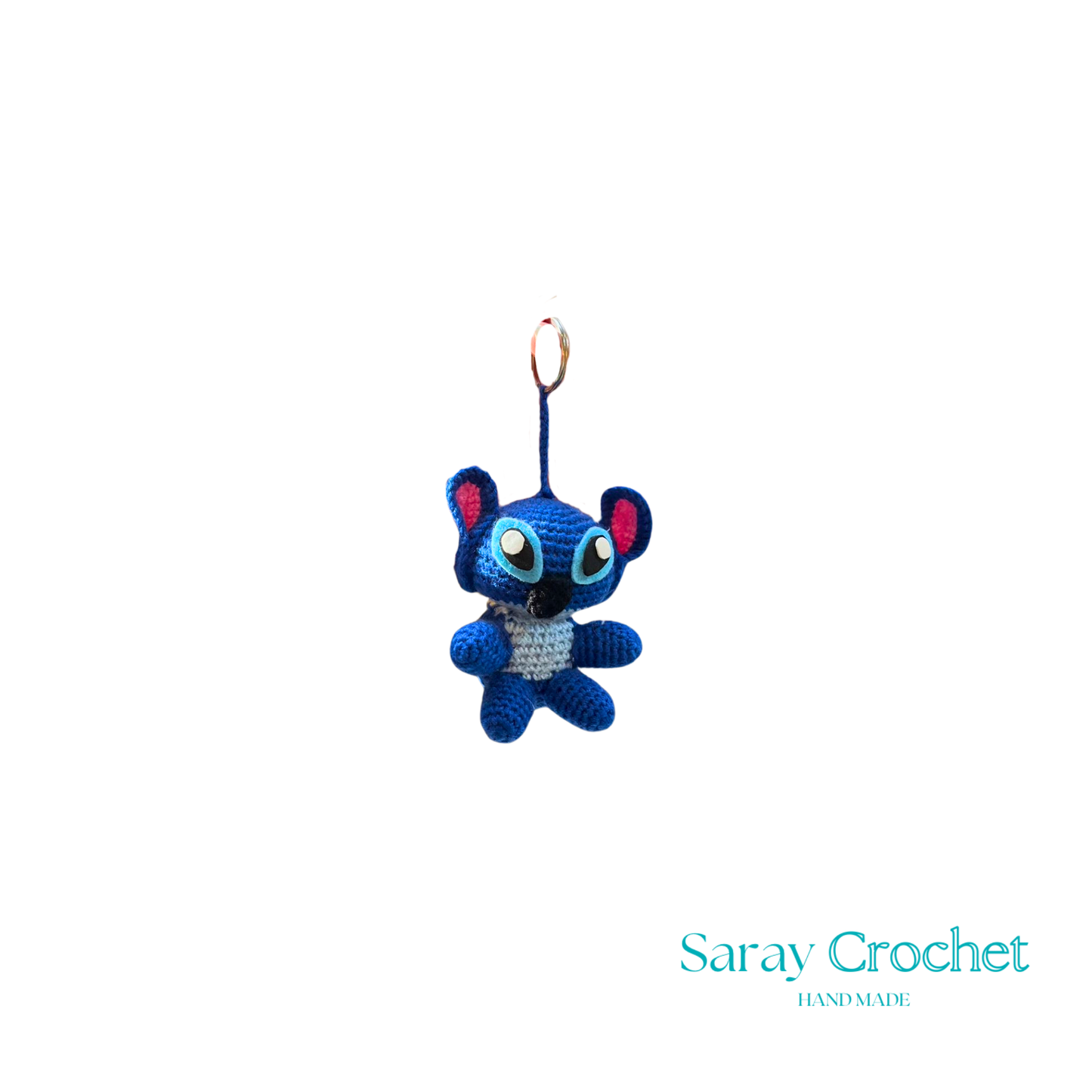 A blue character keychain with a design resembling a stitch from a fabric or crochet pattern.