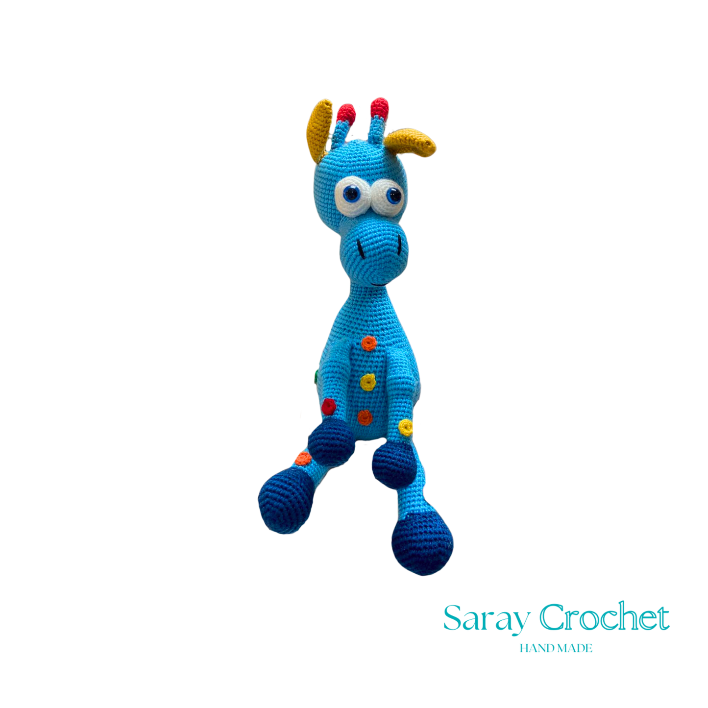 A handcrafted blue and pink giraffe toy with patterned details, standing upright.