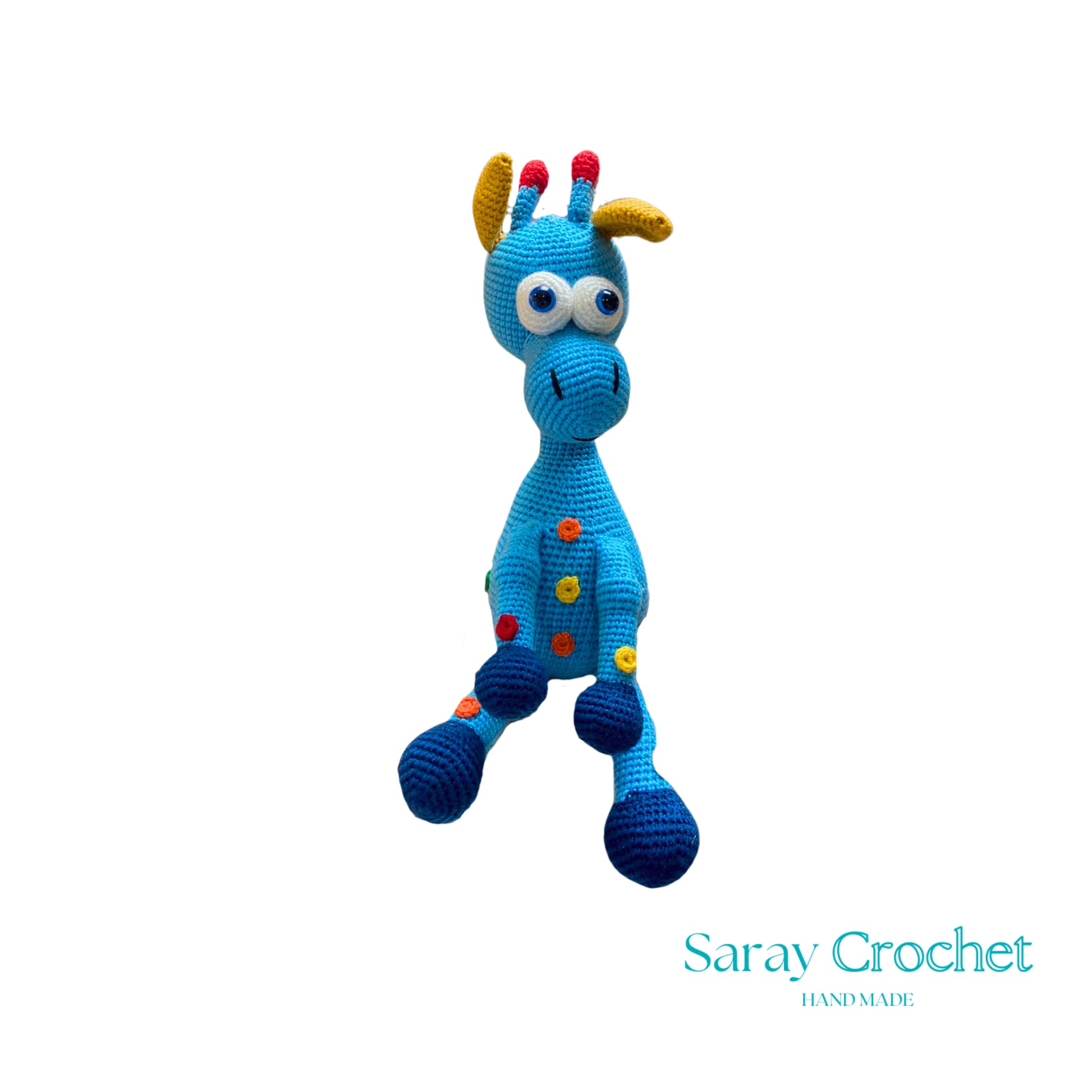 A handcrafted blue and pink giraffe toy with patterned details, standing upright.