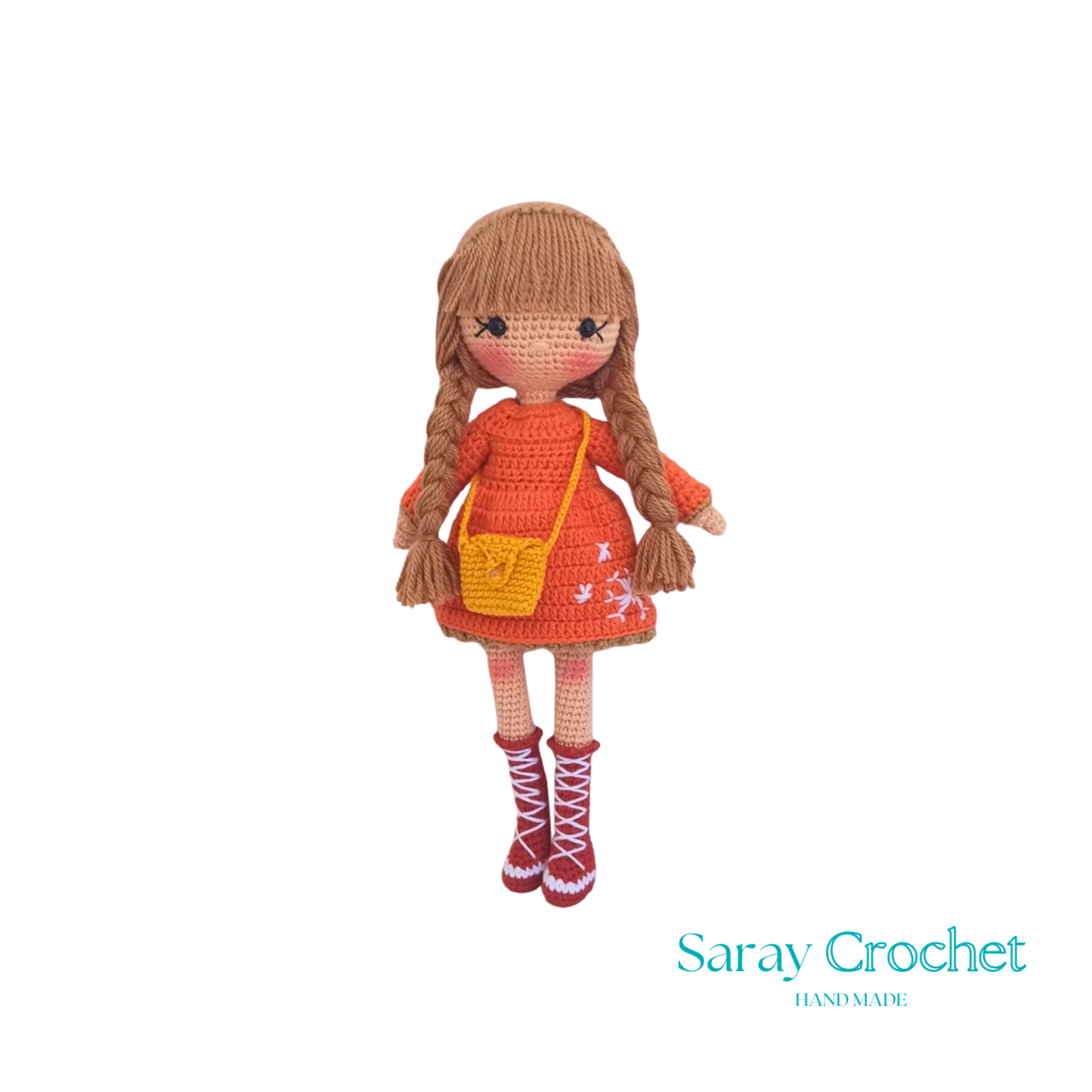 Handmade crocheted doll with orange winter coat and scarf, beige boots, and brown hair.