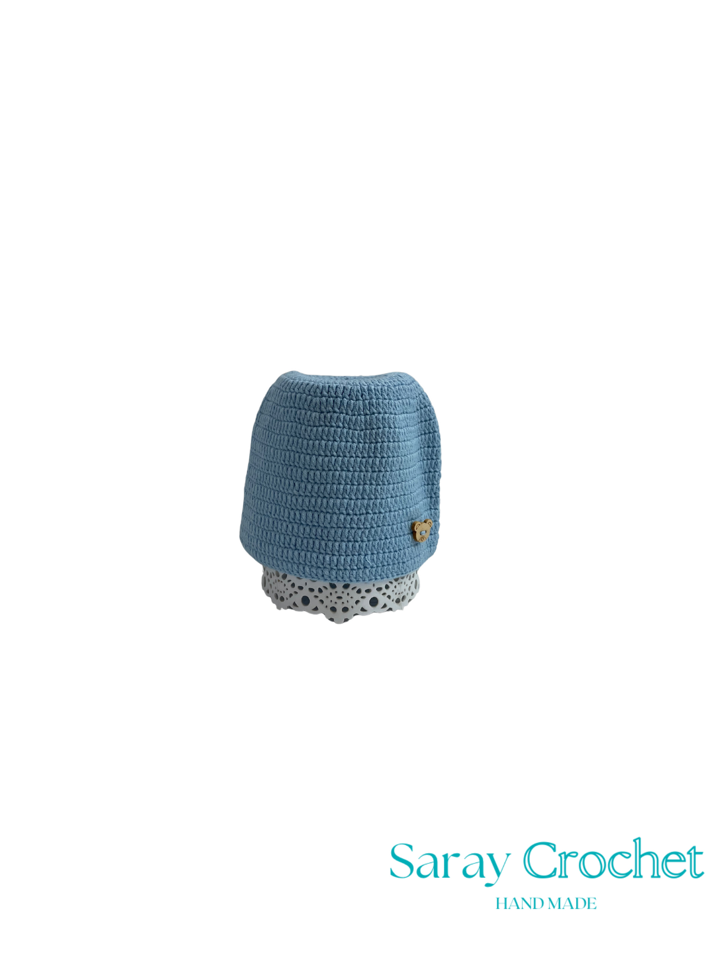Blue crocheted hat with a white polka dot band on a white background, branded 'Saray Crochet'.