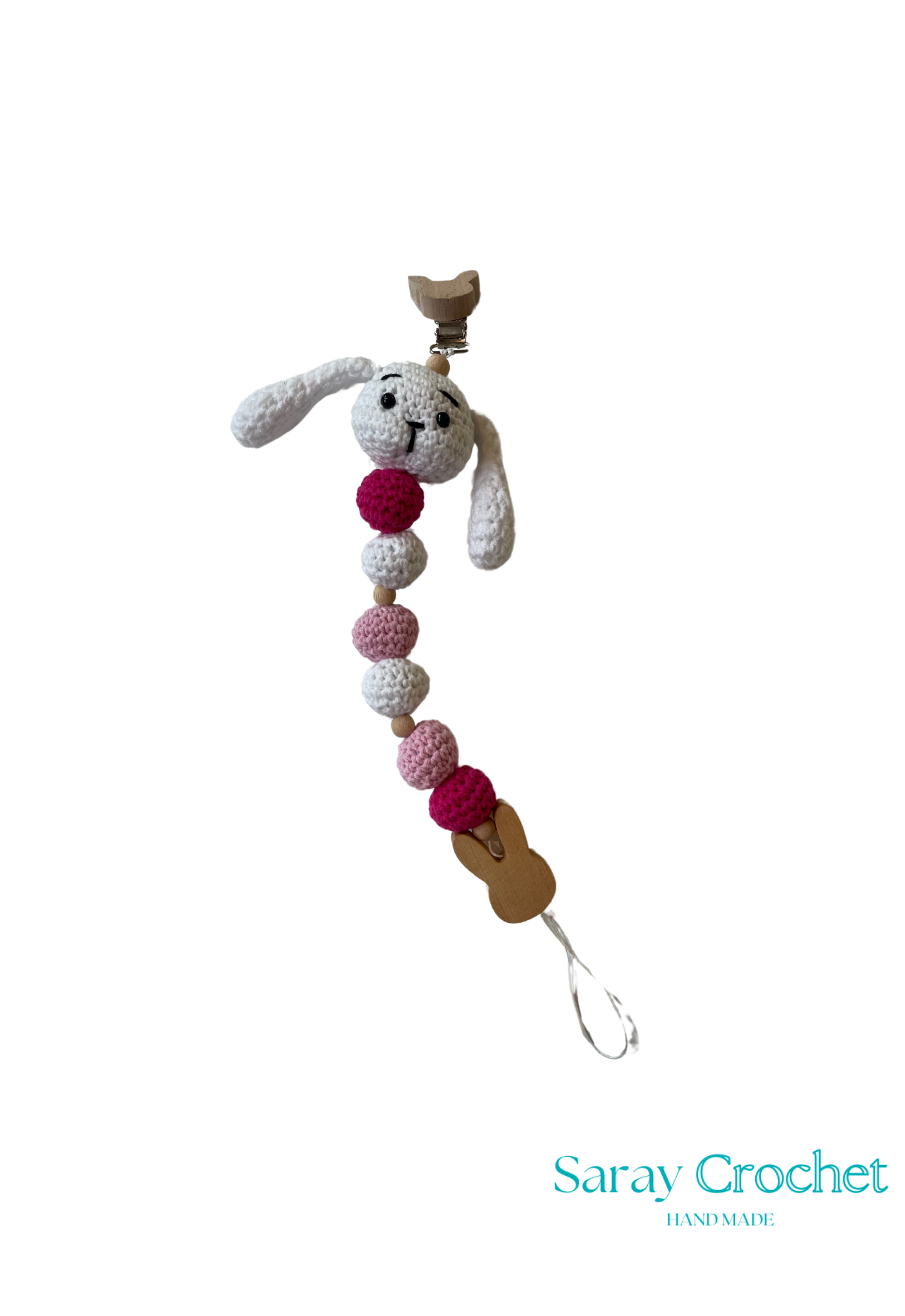 A crochet pacifier holder featuring a blue and beige rabbit design with multicolored beads and a blue pacifier clip.