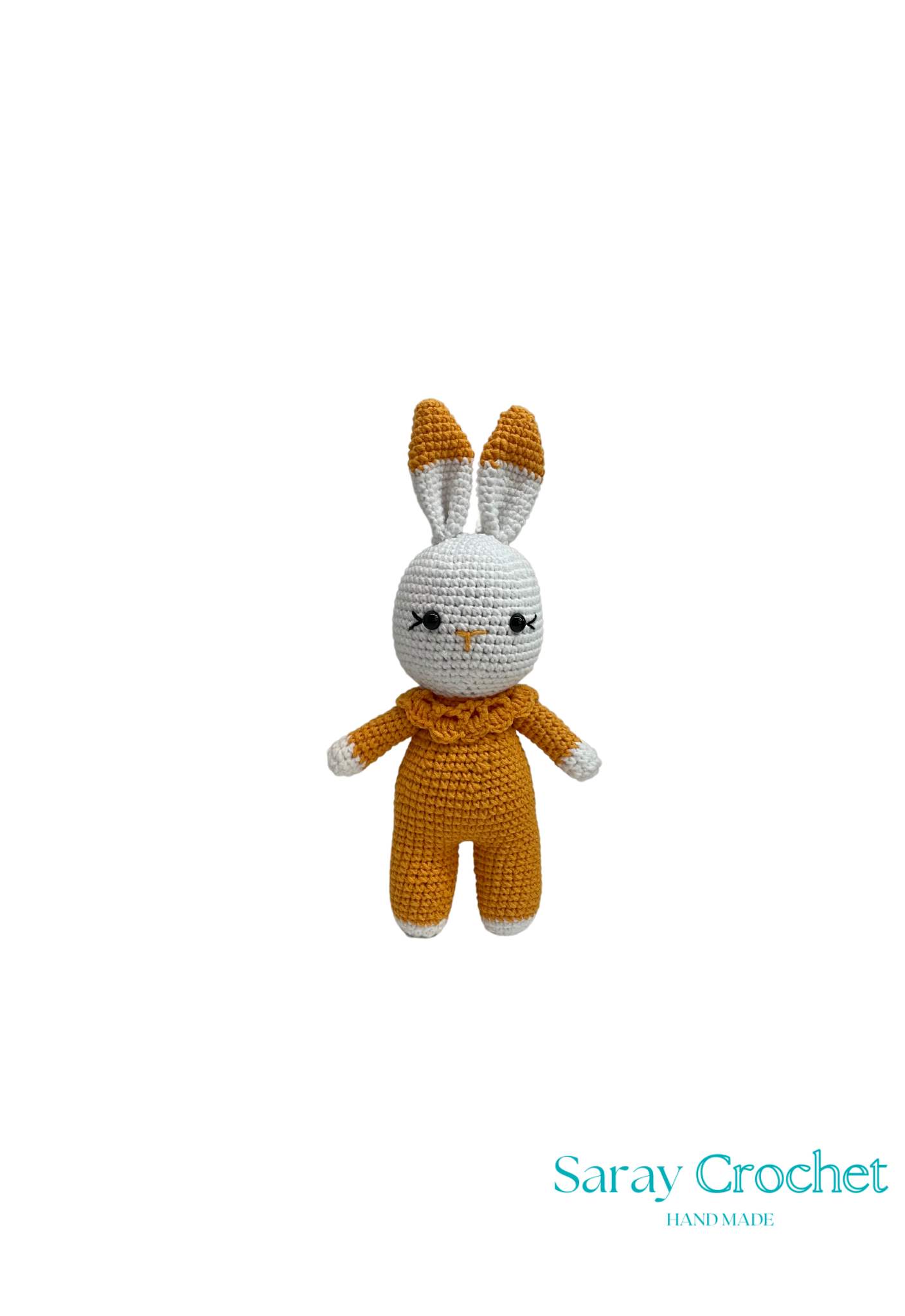Crocheted bunny toy in mustard yellow outfit on white background