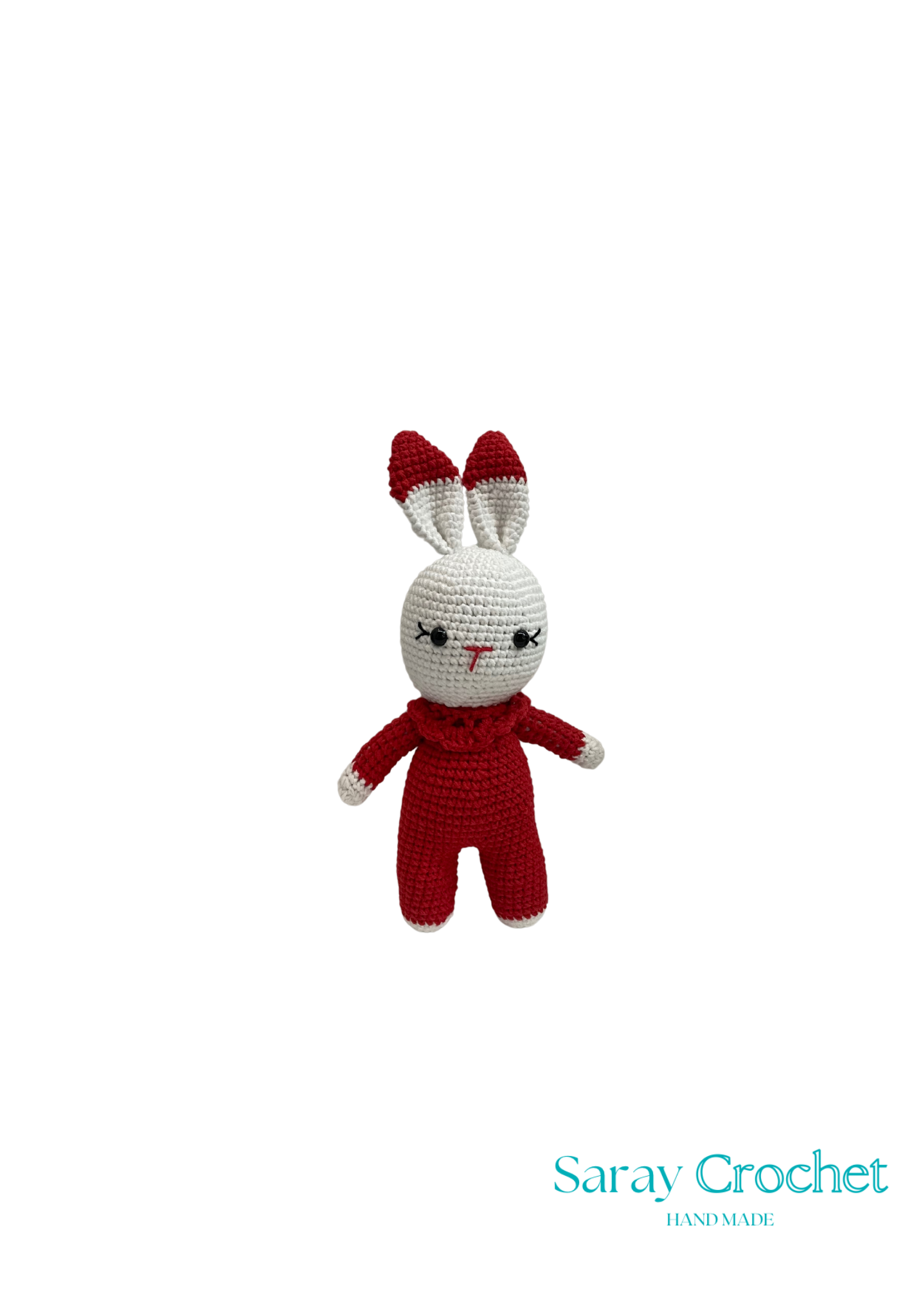 Crocheted rabbit toy in red outfit on white background