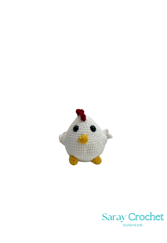 A crocheted plush toy resembling the character Red from the Angry Birds game series.
