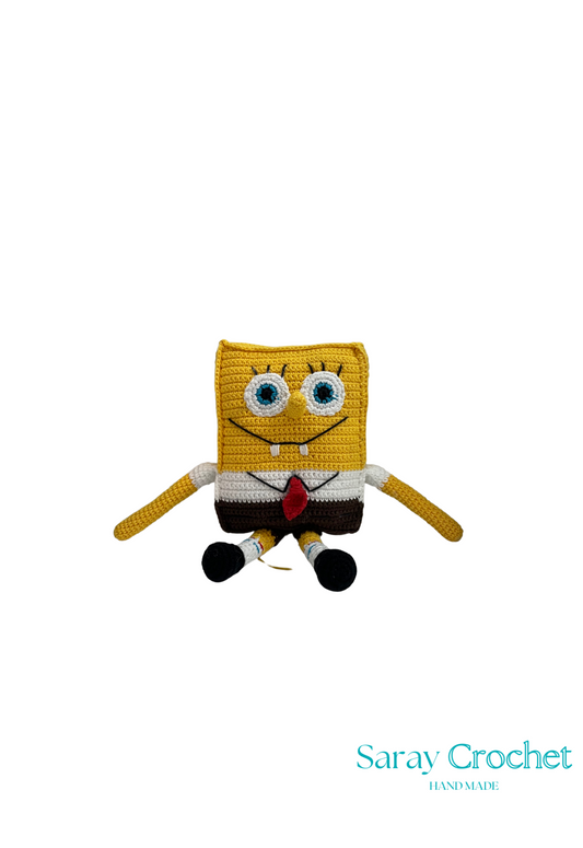 Handmade crochet doll resembling a cartoon character with a yellow body, black eyes, and a red tie, named Spučva Bob.