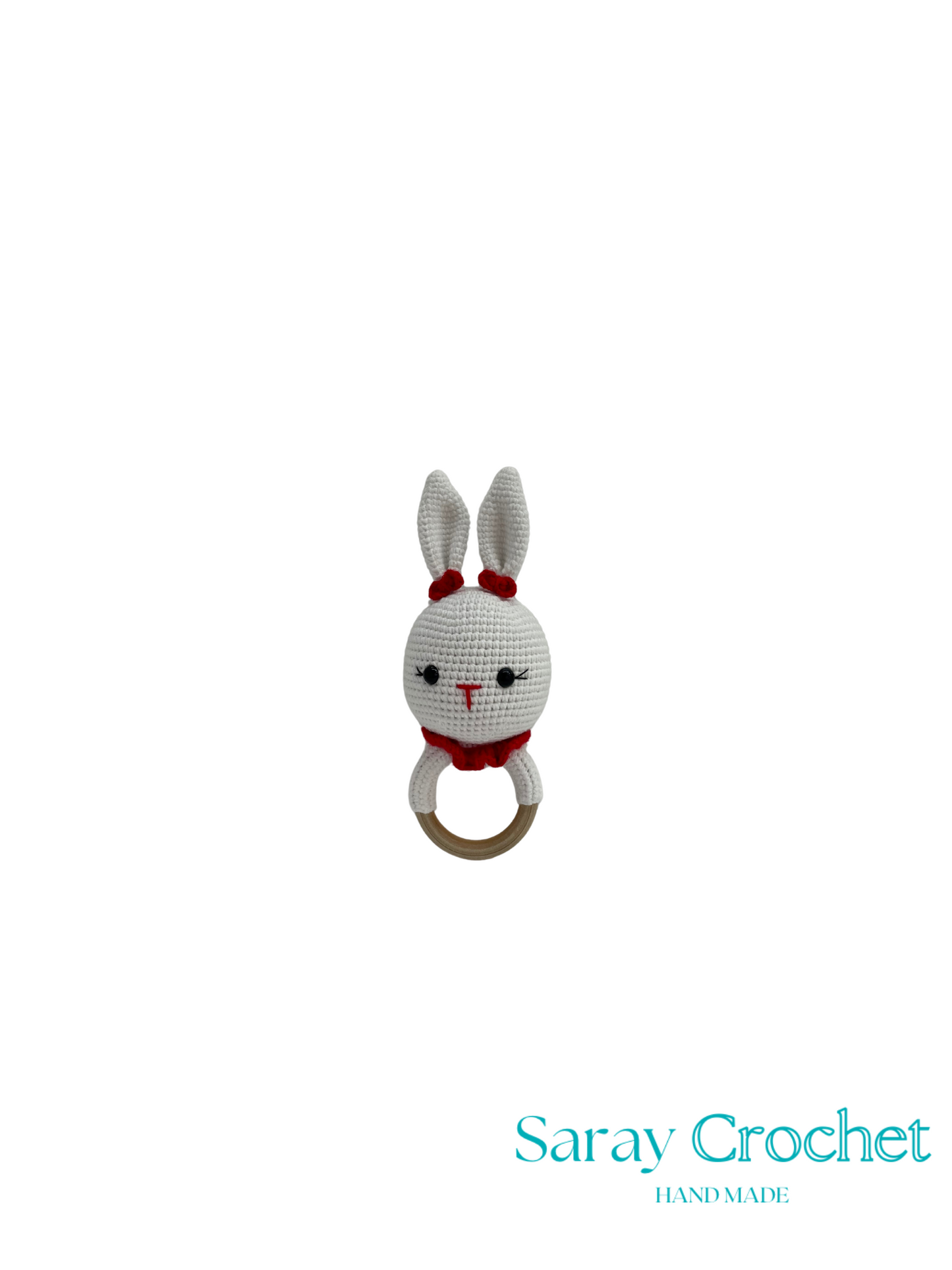 Crocheted rabbit rattle with a wooden ring on a white background, branded 'Saray Crochet'.