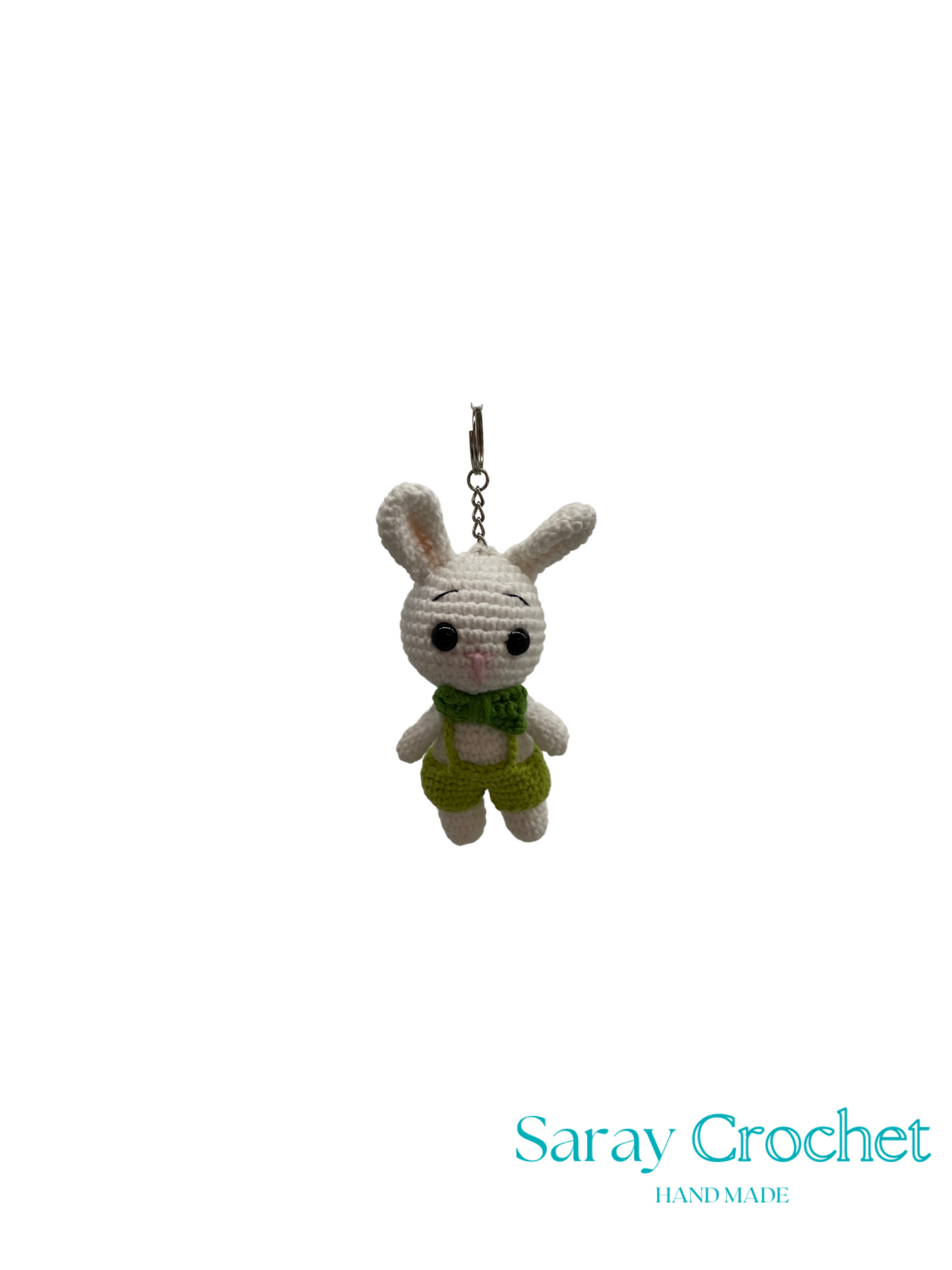 Crocheted bunny keychain with a green bow tie on a white background, branded 'Saray Crochet'.