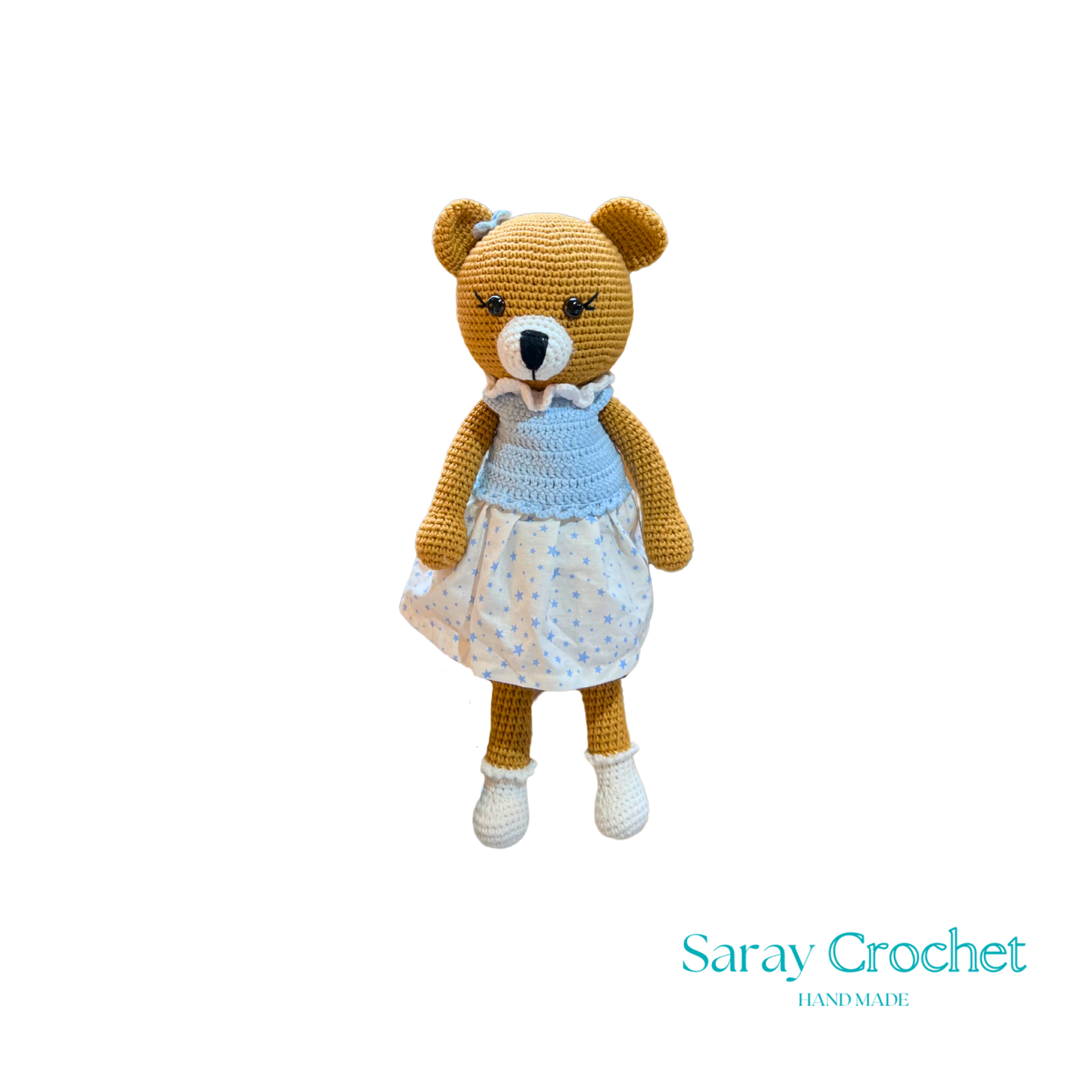 Handmade plush toy resembling a bear with a blue dress and white shoes, on a white background.