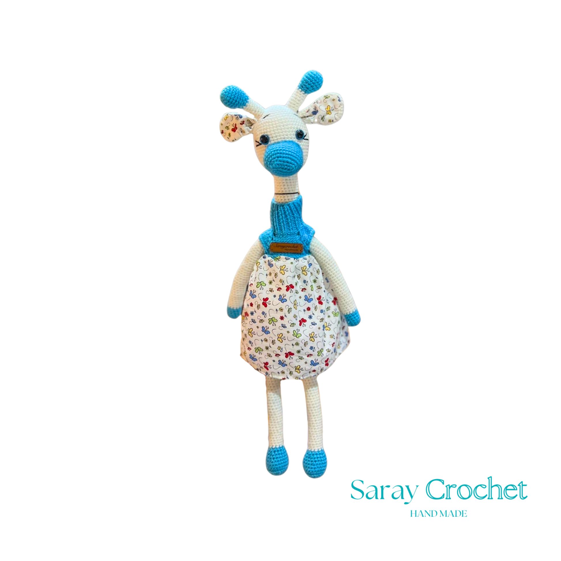 Handmade plush giraffe toy with a floral dress and blue accents, equipped with a pacifier.