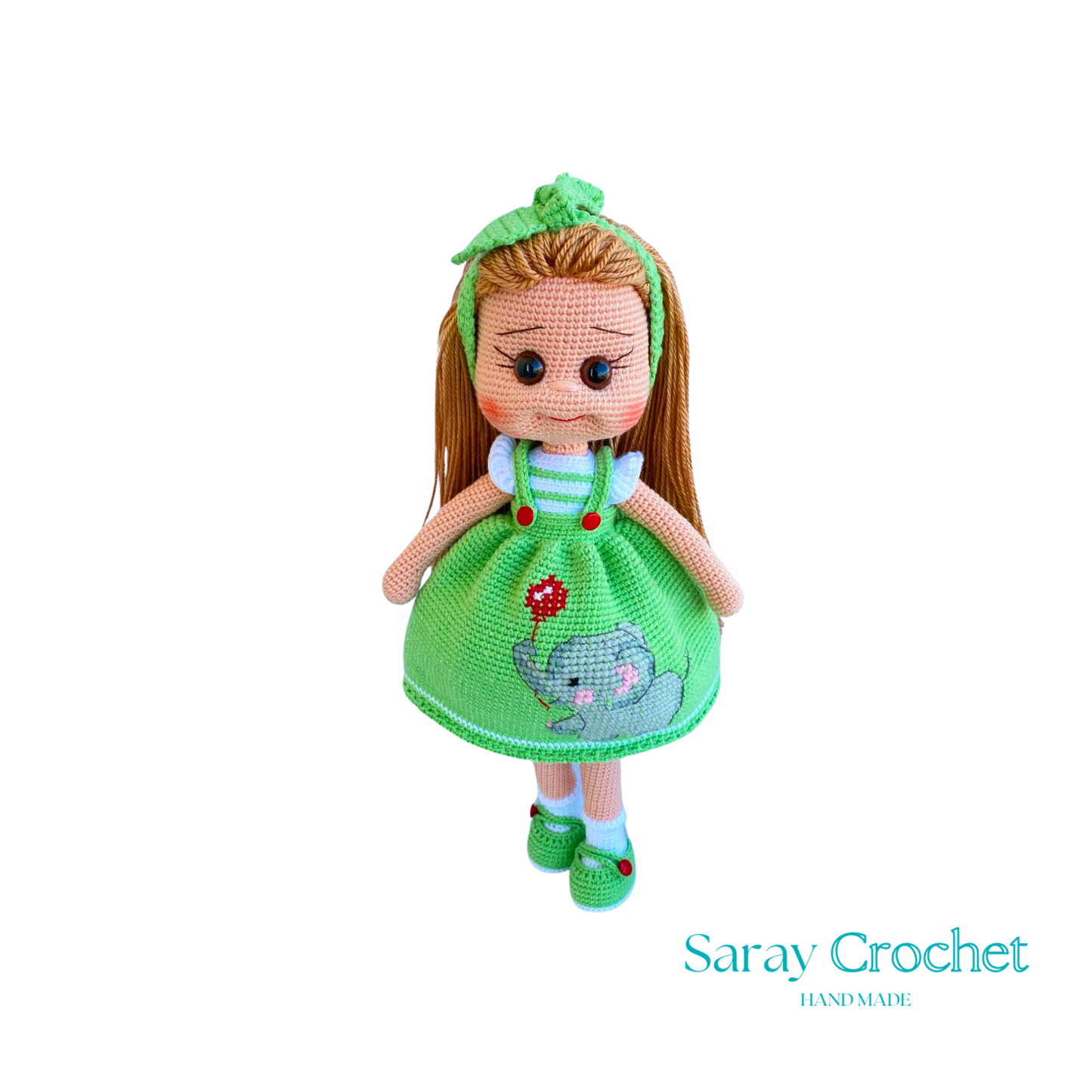 Handmade doll with light green dress, featuring a hand-embroidered snail motif, and a matching green bow in her hair.