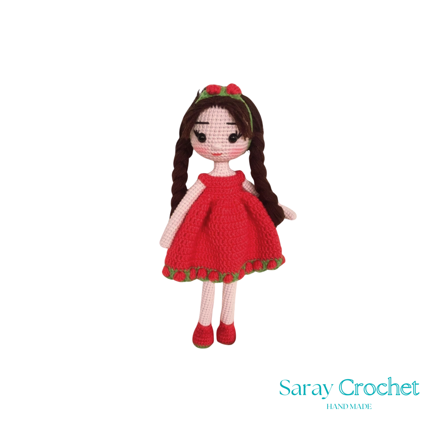 A handcrafted doll with a red dress and matching red shoes, featuring a green hairband with a bow.