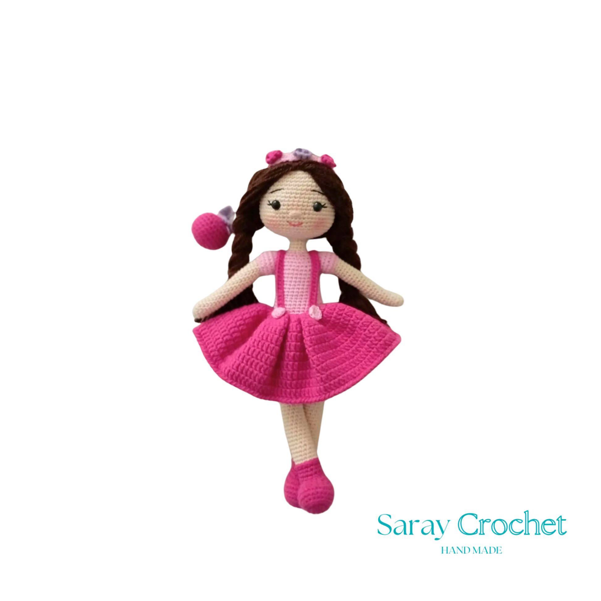 A handcrafted doll with a pink and white outfit, featuring a floral headband and matching shoes.