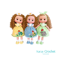 Three handcrafted dolls with curly hair, each wearing a uniquely designed dress in yellow, blue, and green colors.