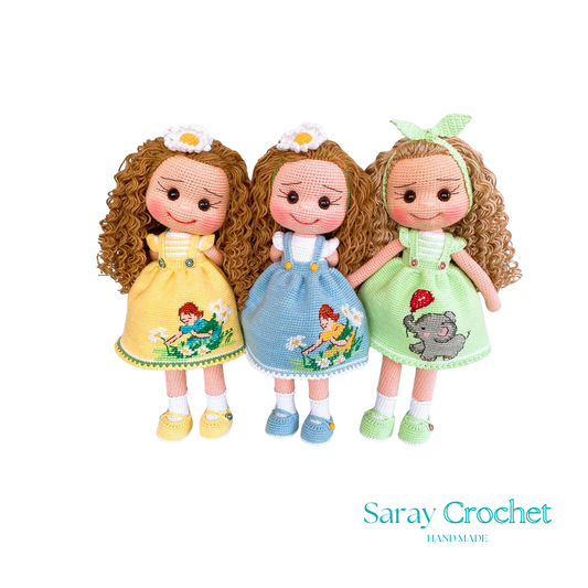 Three handcrafted dolls with curly hair, each wearing a uniquely designed dress in yellow, blue, and green colors.