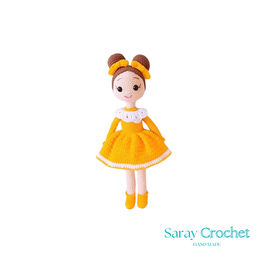 Handmade doll with a yellow dress and white apron, wearing a brown hat with a bow, and matching yellow shoes.