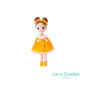 Handmade doll with a yellow dress and white apron, wearing a brown hat with a bow, and matching yellow shoes.