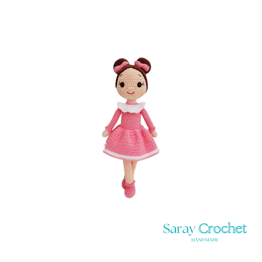 A handcrafted doll with a pink dress and bow, standing 30 cm tall.