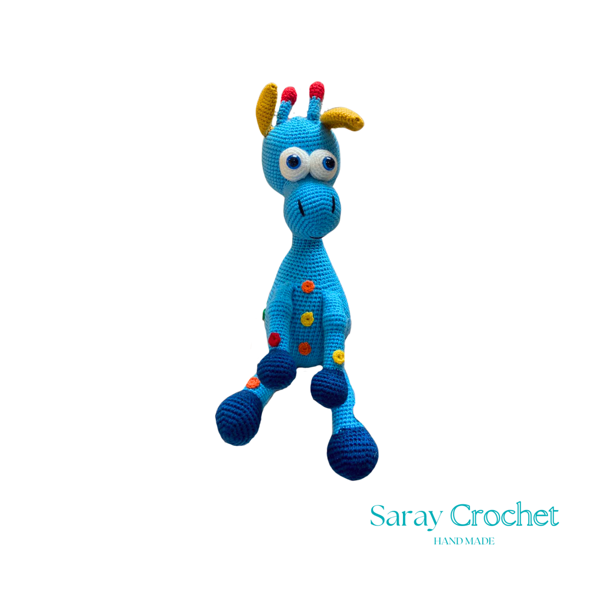 A handcrafted blue and pink giraffe toy with patterned details, standing upright.