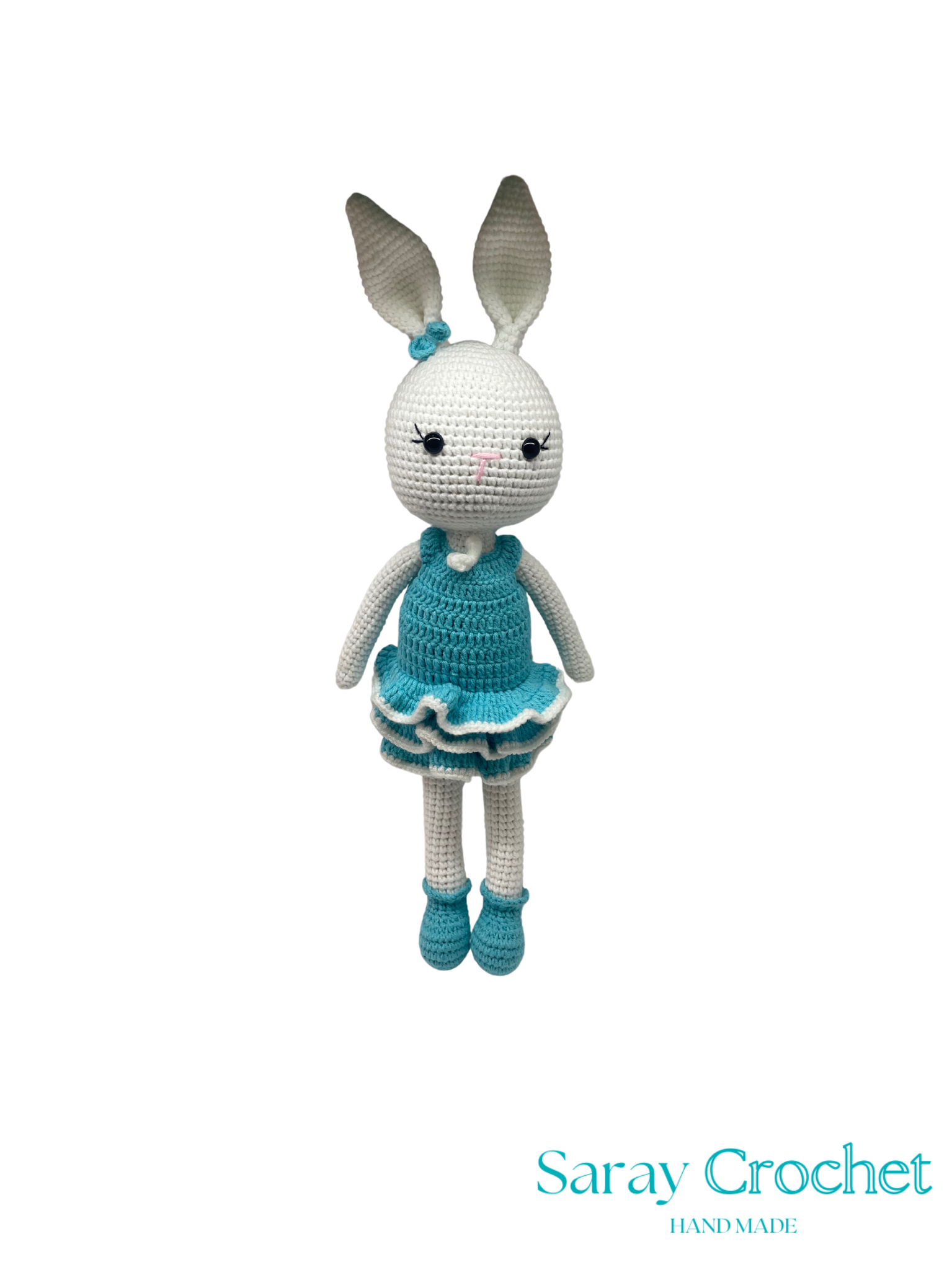 Crocheted bunny toy with a blue dress on a white background, branded 'Saray Crochet'.