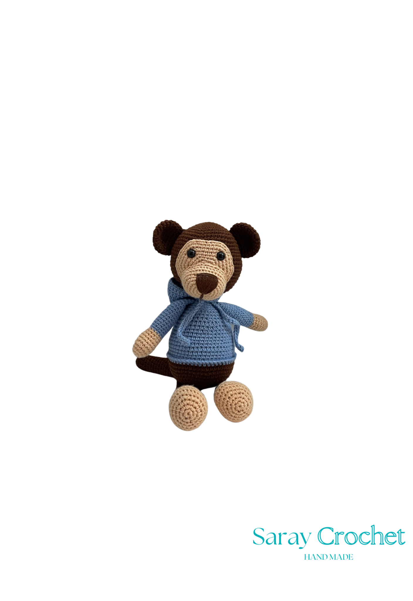Crocheted monkey toy with a blue sweater on a white background, branded 'Saray Crochet'.