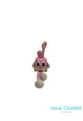 Crocheted pink and beige animal toy on a white background with 'Saray Crochet' branding.