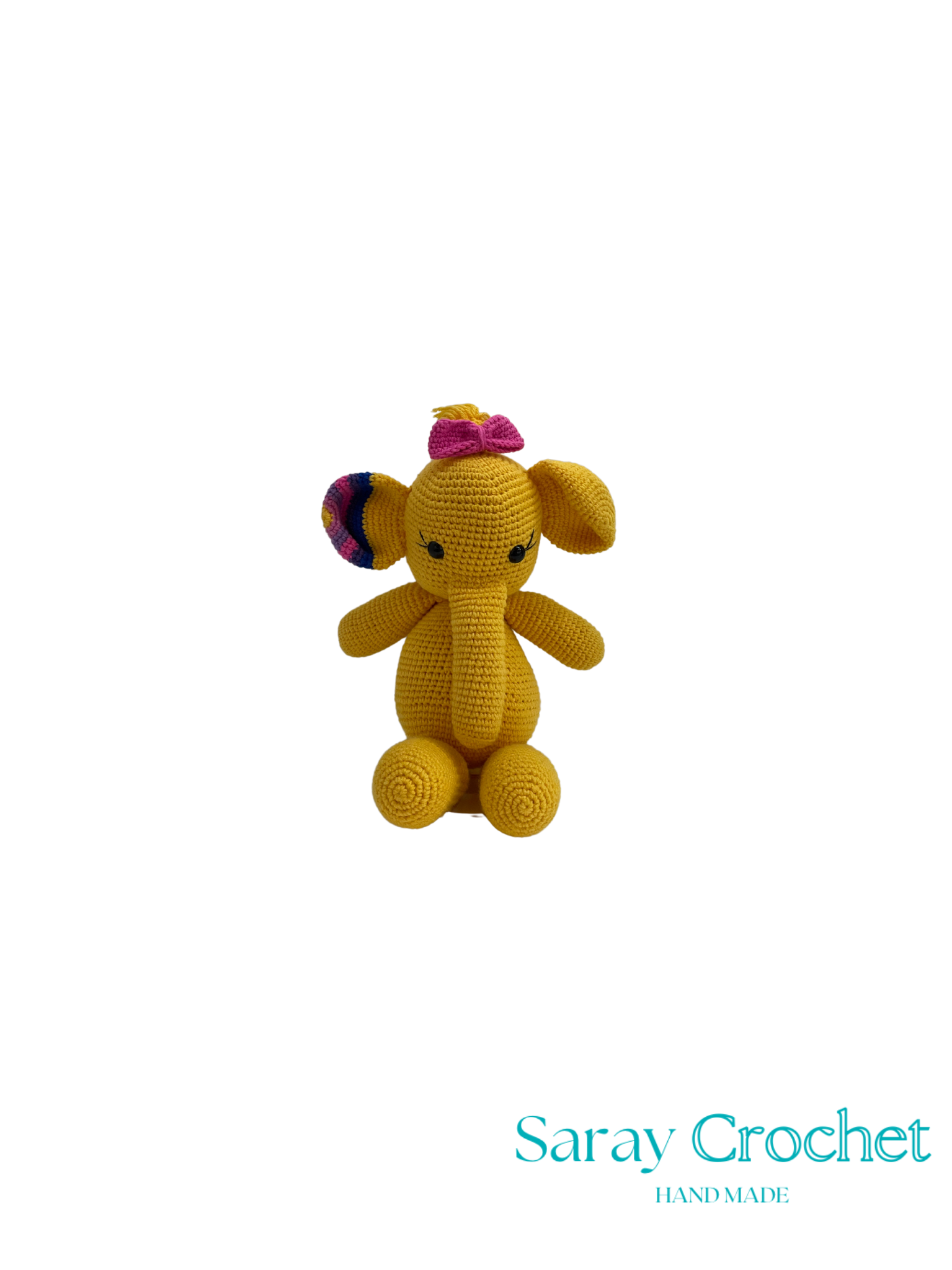 Crocheted yellow elephant toy with a pink bow on a white background, branded 'Saray Crochet'.