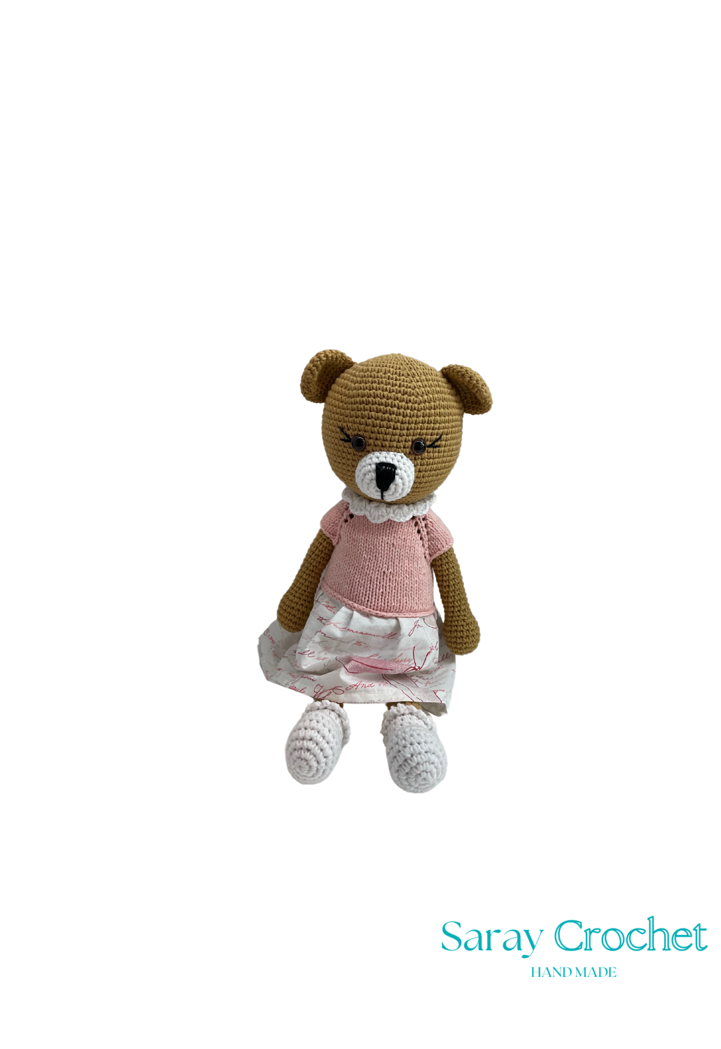 Handmade plush toy resembling a bear with a white-pink dress, sitting upright.