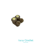 Pair of brown knitted baby booties with yellow labels on a white background, branded 'Saray Crochet'.