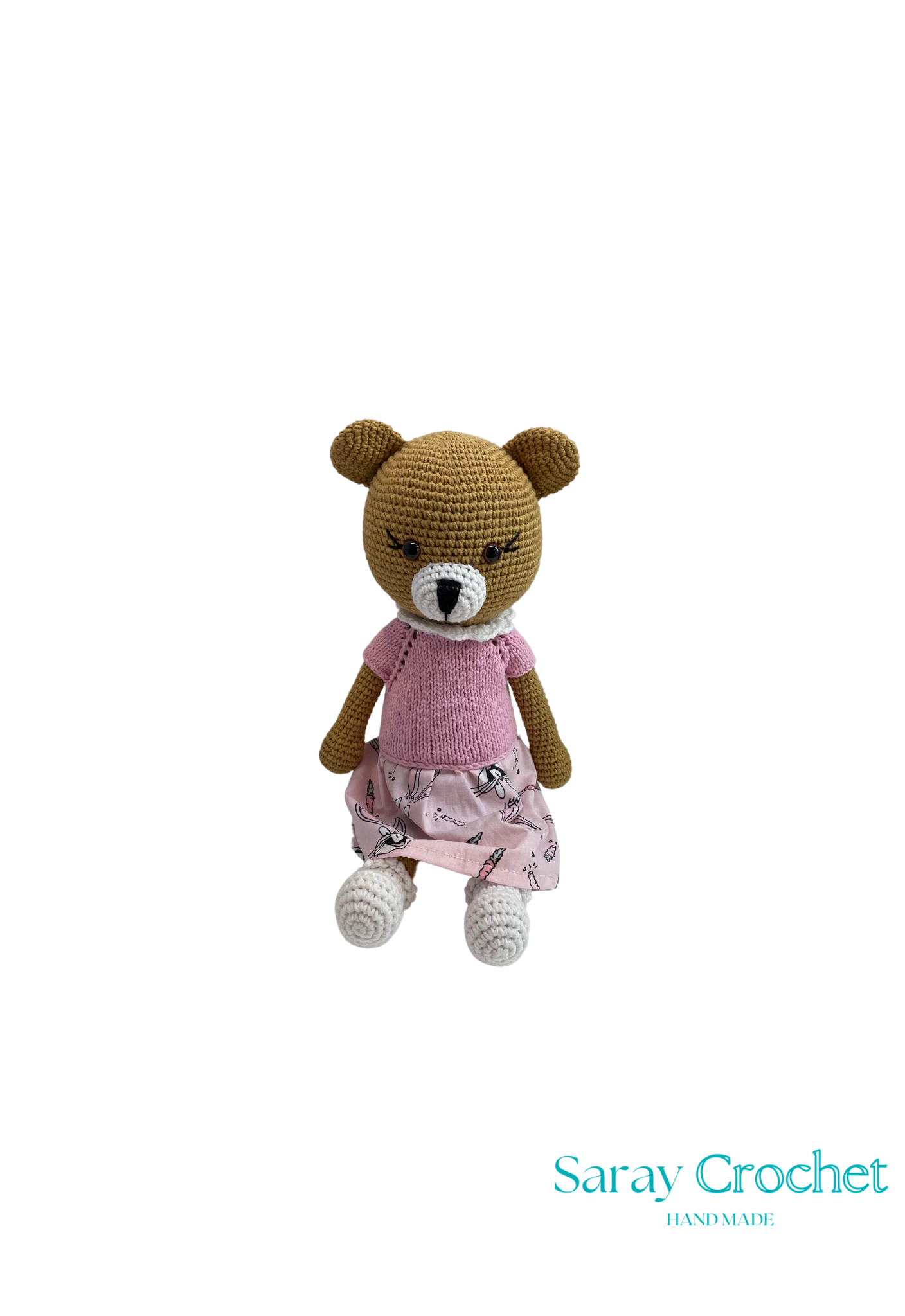 Handmade plush toy resembling a bear with a pink dress, sitting upright.