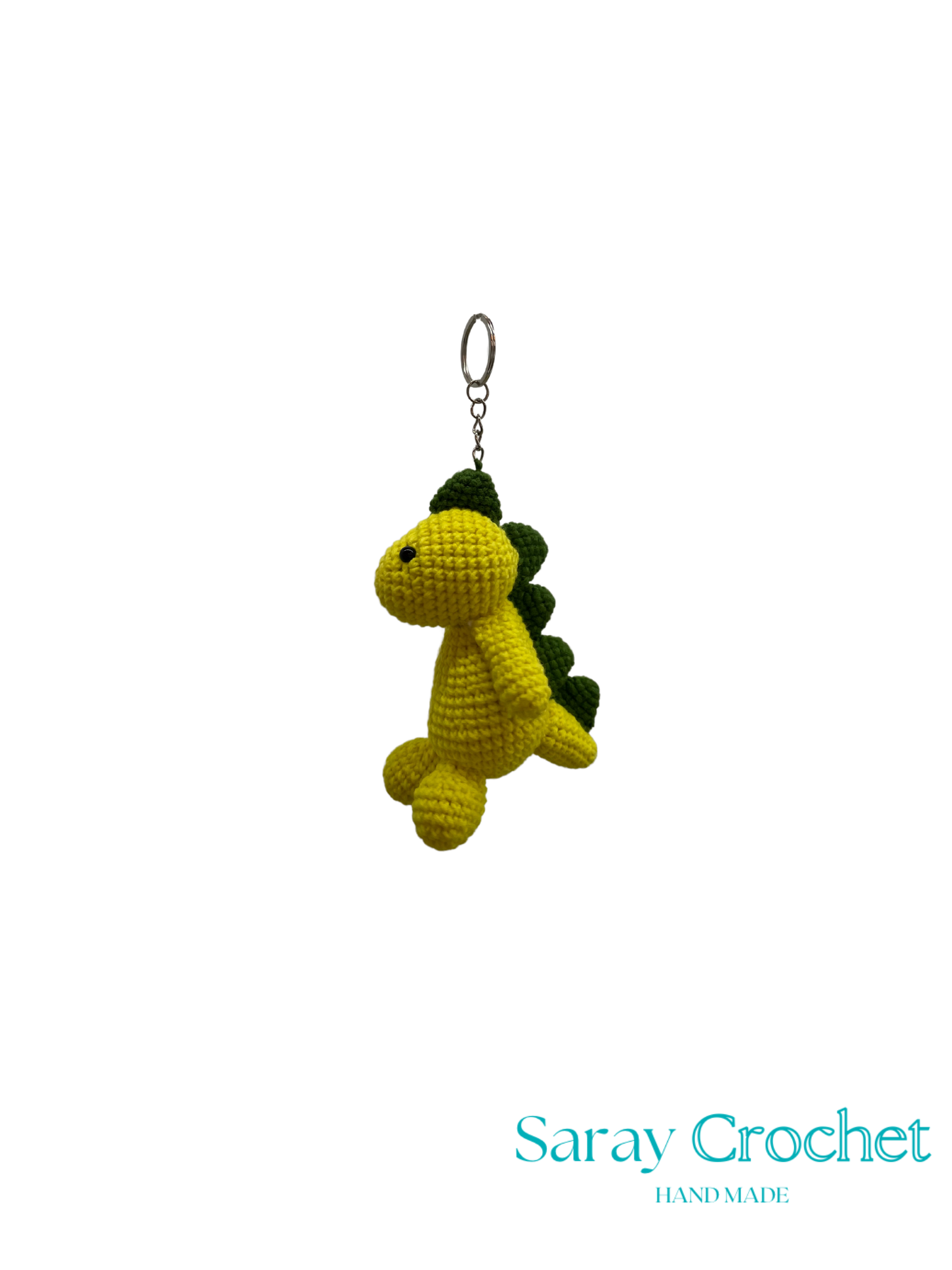 Crocheted dinosaur keychain on a white background with 'Saray Crochet' branding.