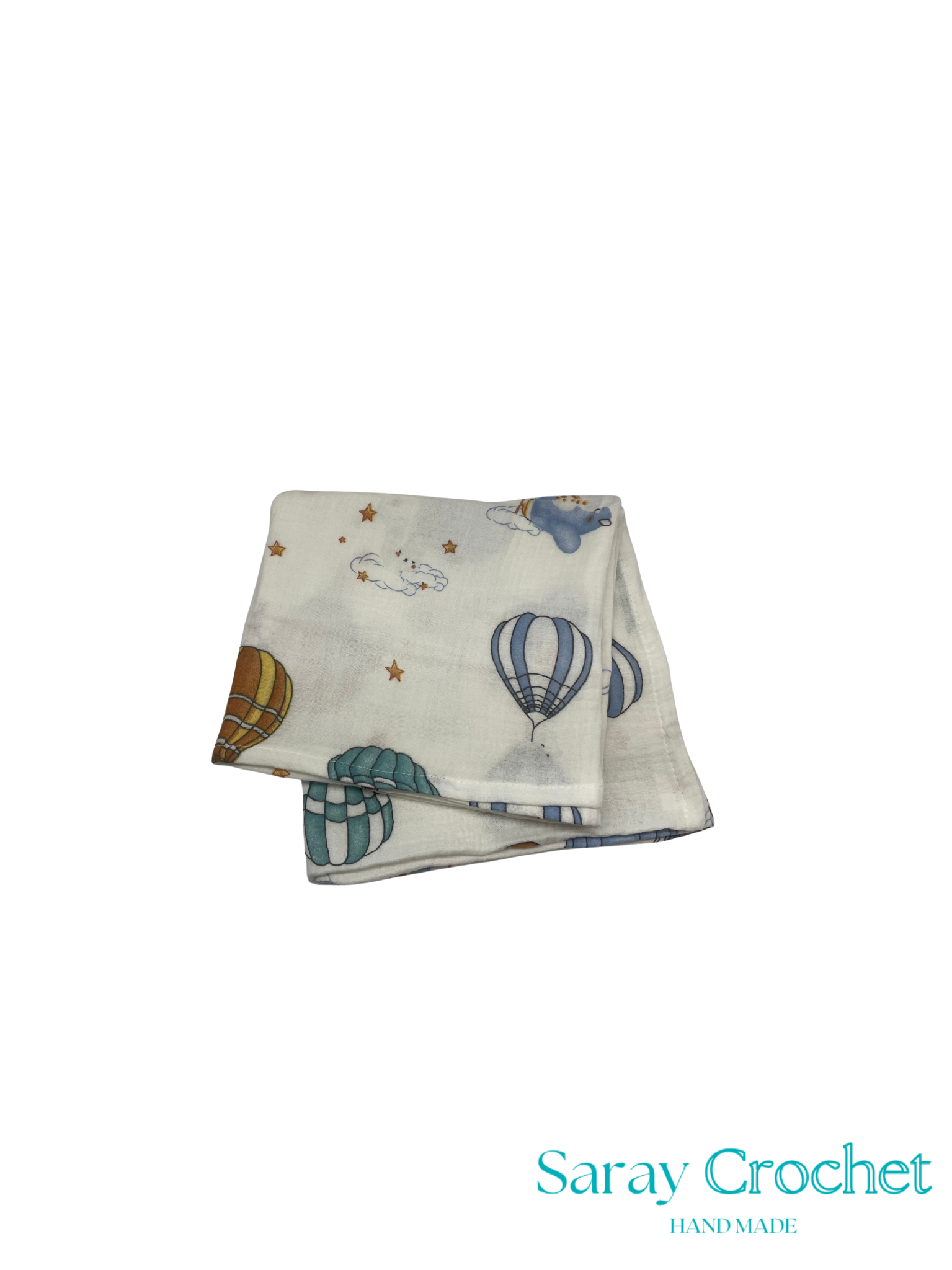 Folded fabric with hot air balloon pattern on a white background, branded 'Saray Crochet'.