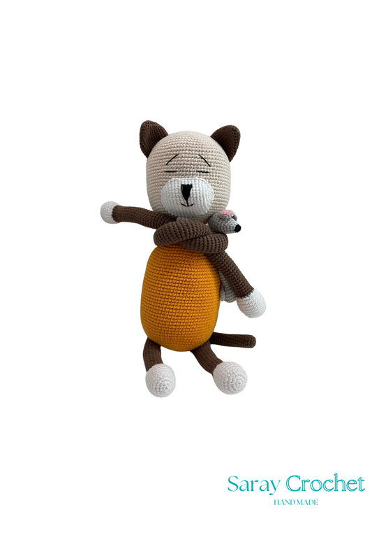 A handcrafted plush toy depicting a cat hugging a mouse, made from cotton yarn in brown, white, and beige colors.