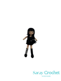 Small doll with black hair and outfit on a white background, branded 'Saray Crochet'.