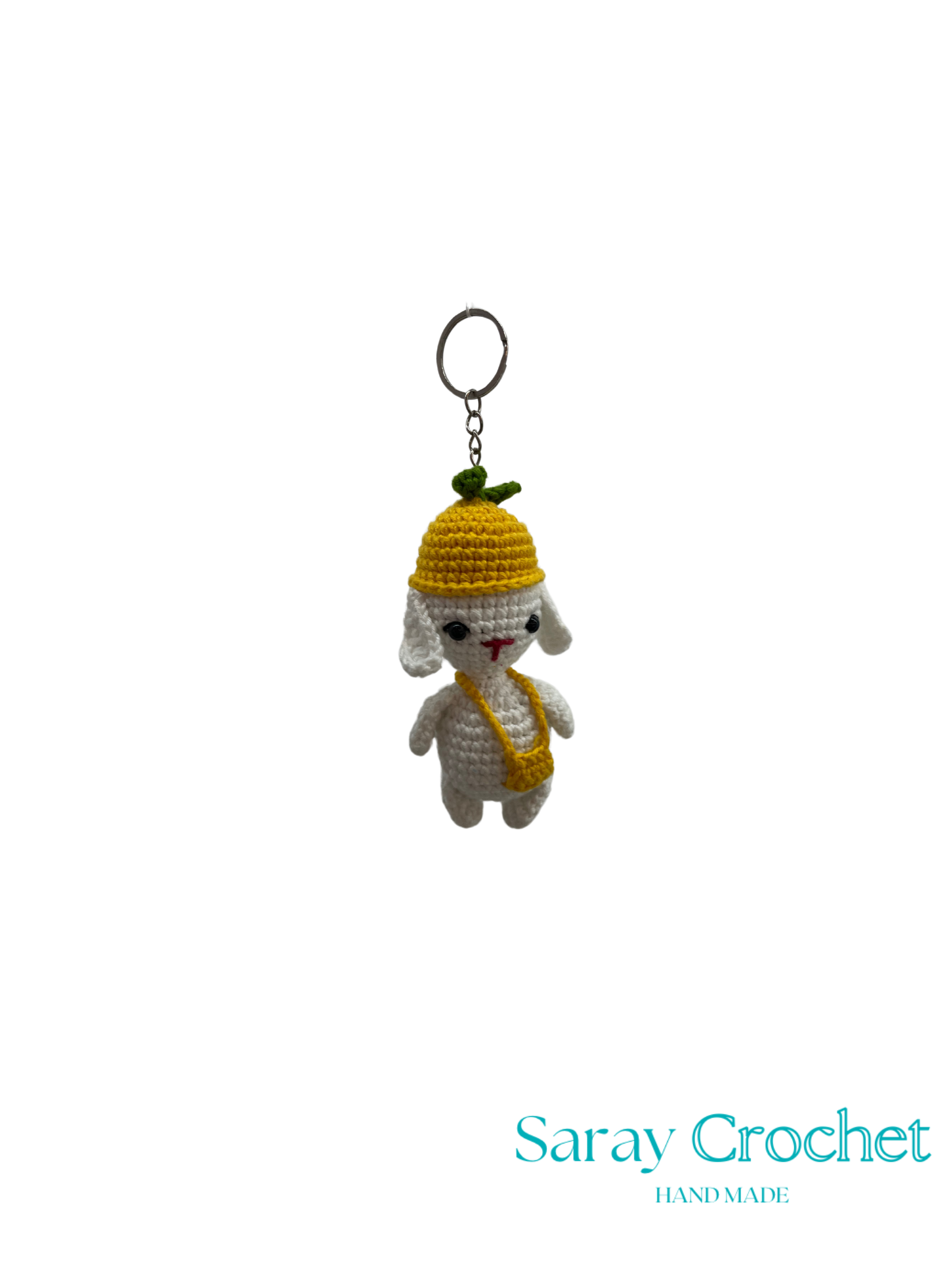 Crocheted sheep keychain with yellow hat and scarf on a white background, branded 'Saray Crochet'.
