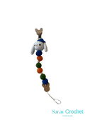 Crocheted snowman ornament with colorful beads on a white background, branded 'Saray Crochet'.