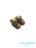 Pair of brown crochet baby booties with white accents on a white background, branded 'Saray Crochet'.