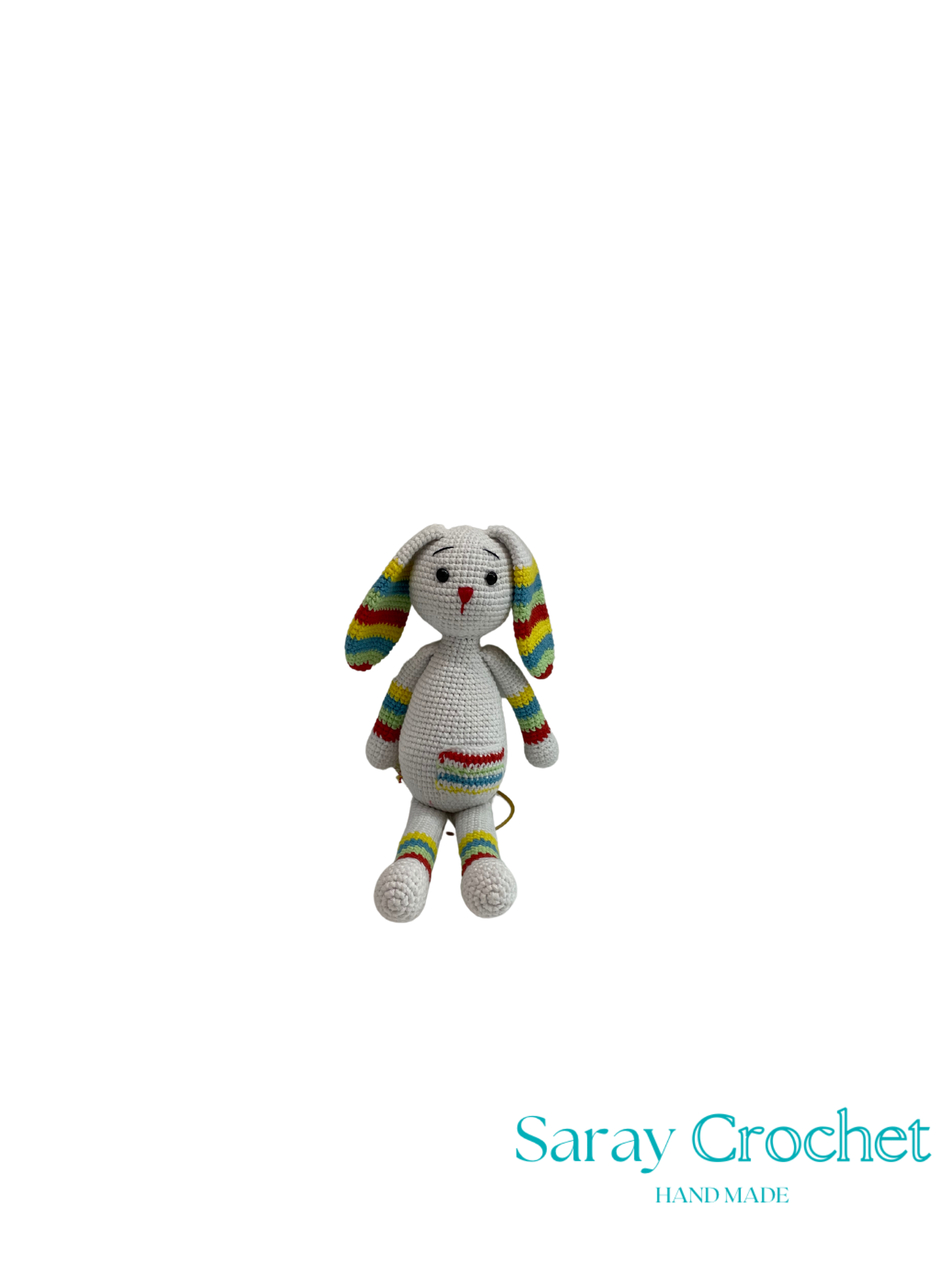 Crocheted rabbit toy with rainbow pattern on a white background, branded 'Saray Crochet'.
