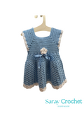 Crocheted blue dress on a hanger with 'Saray Crochet' branding.