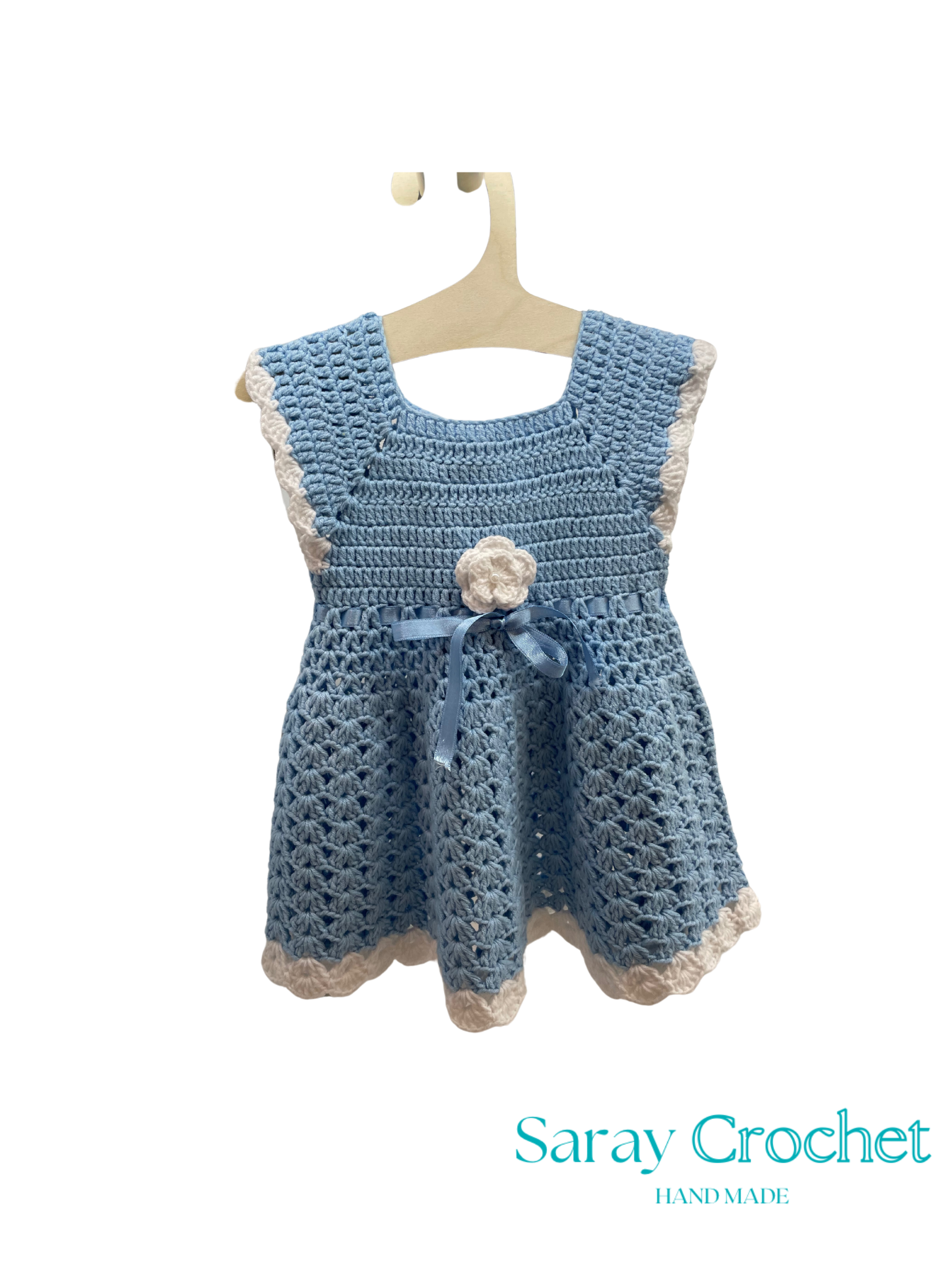 Crocheted blue dress on a hanger with 'Saray Crochet' branding.
