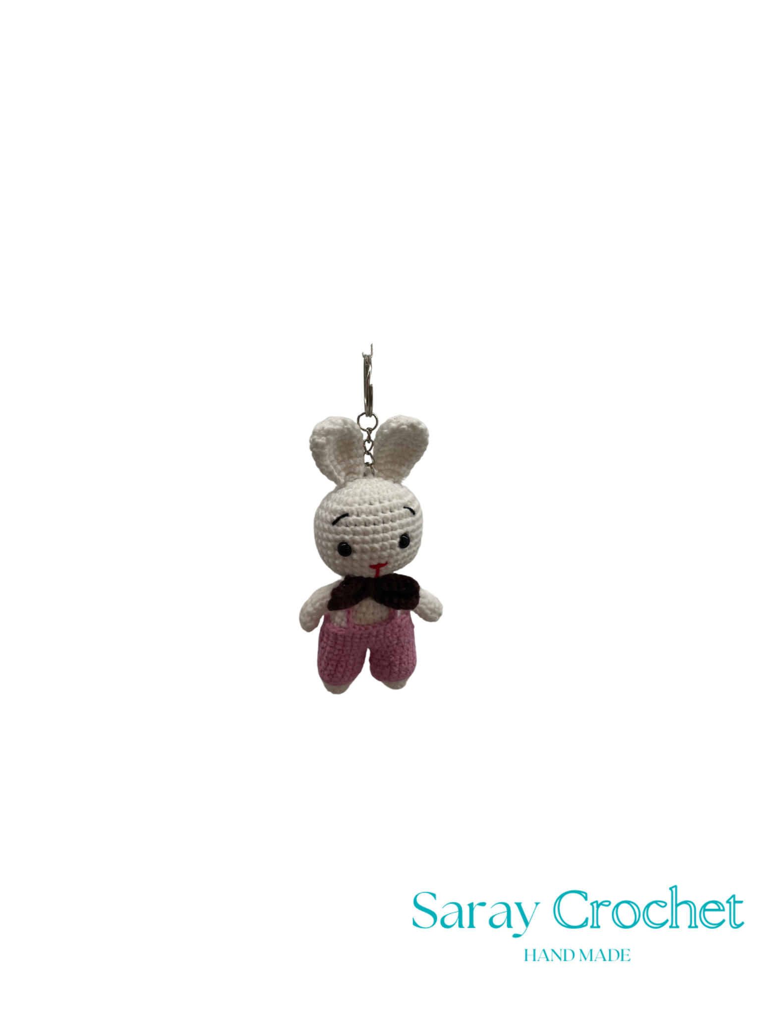 Crocheted bunny keychain with a black bow tie on a white background, branded 'Saray Crochet'.