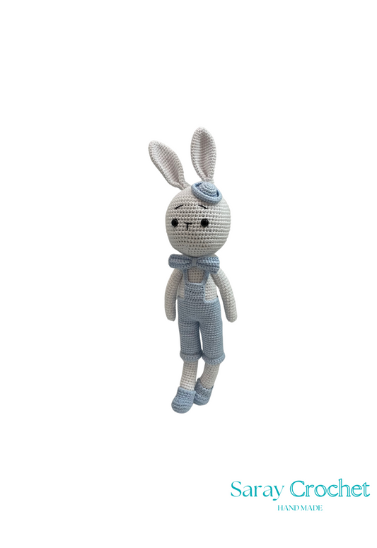 Handmade plush toy resembling a rabbit with blue bow and bowler hat, made from cotton, by SarayCrochet.