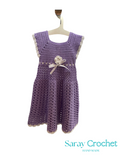 Purple crocheted dress with a white flower on a hanger, branded 'Saray Crochet'.