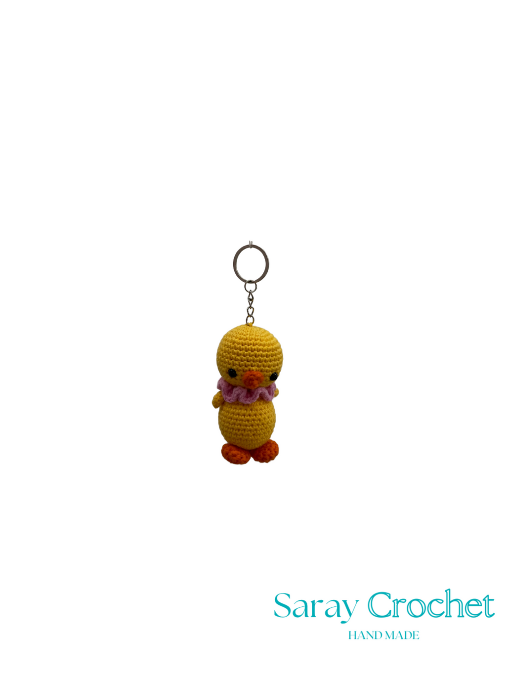 Crocheted duck keychain with floral accessory on a white background, branded 'Saray Crochet'.