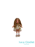 Handmade doll with a dress featuring a turtle design on a white background, branded 'Saray Crochet'.