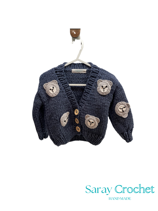 Knitted cardigan with bear designs on a hanger, branded 'Saray Crochet'.