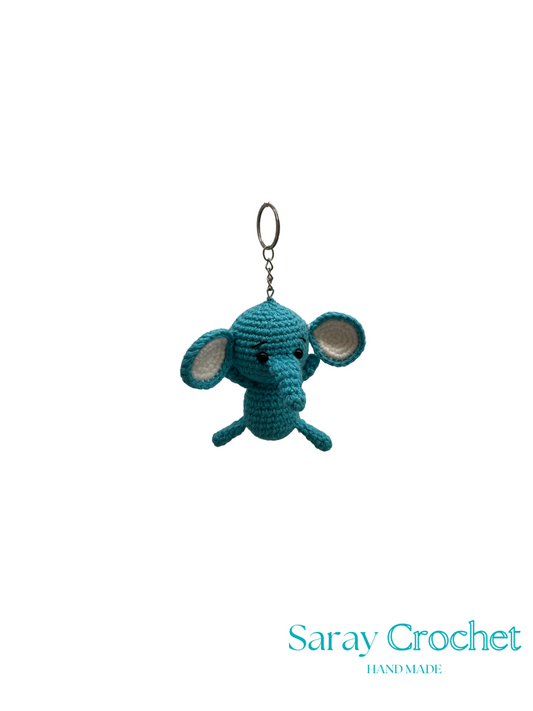 Blue crochet elephant keychain on a white background with 'Saray Crochet' branding.