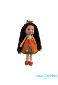 Handmade crochet doll with orange dress and long brown hair, featuring a rabbit motif, standing against a white background with the text 'Saray Crochet'.