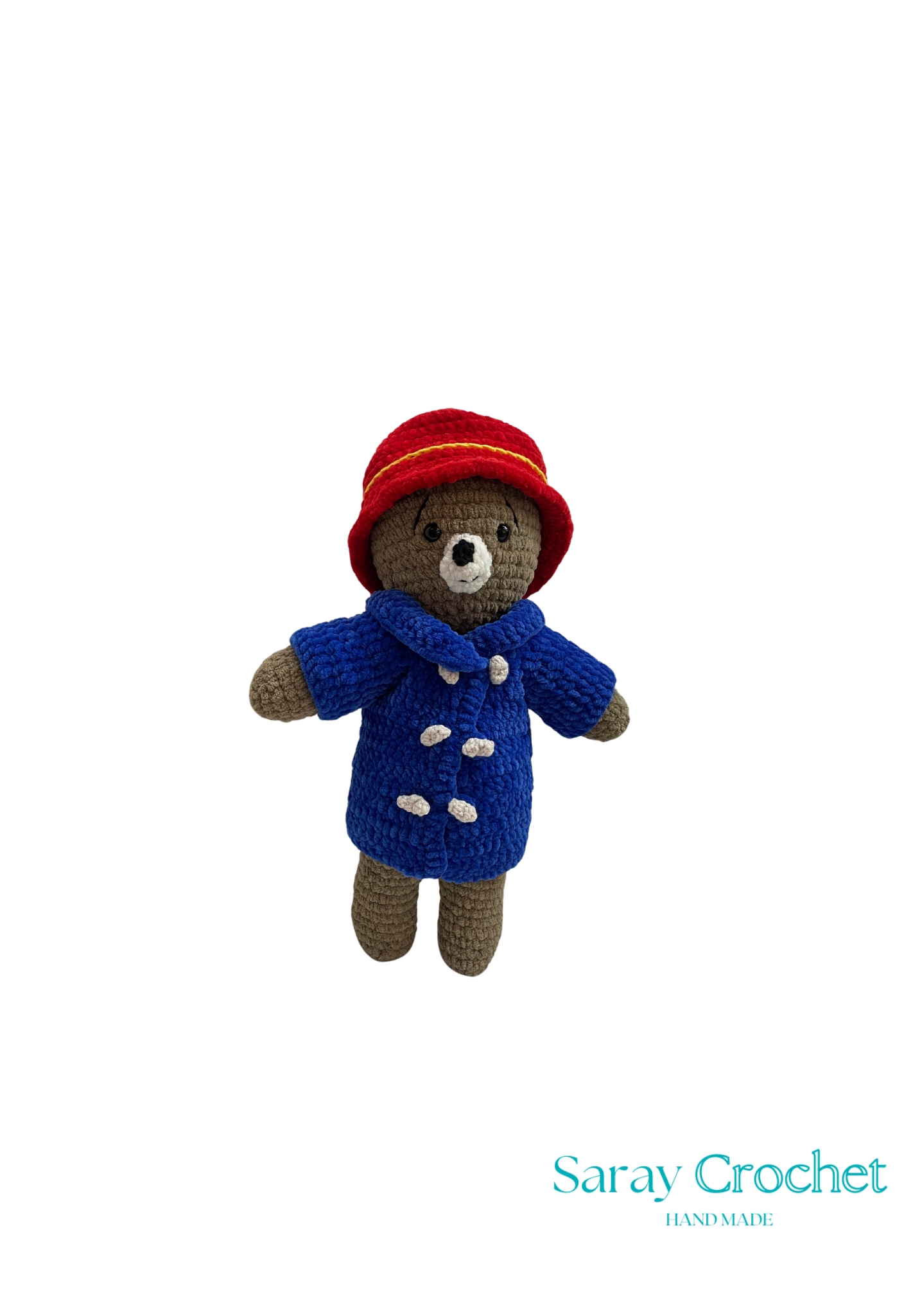 Handmade plush toy resembling Paddington Bear, wearing a blue coat and red hat, standing upright.