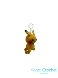 Crocheted Pikachu keychain on a white background with 'Saray Crochet' branding.